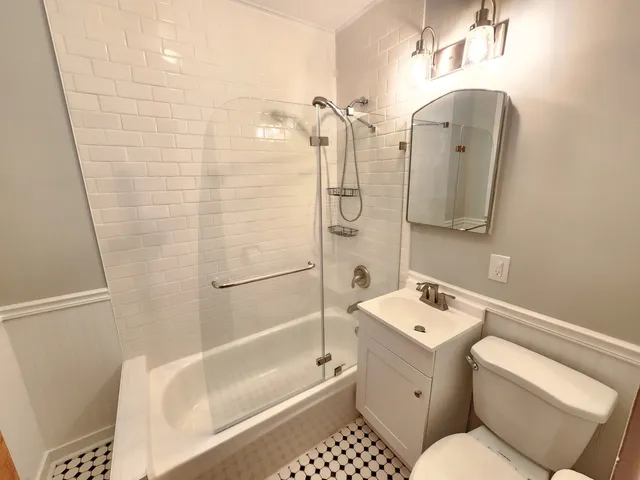 a kitchen with a refrigerator a sink a stove a refrigerator cabinets and wooden floor