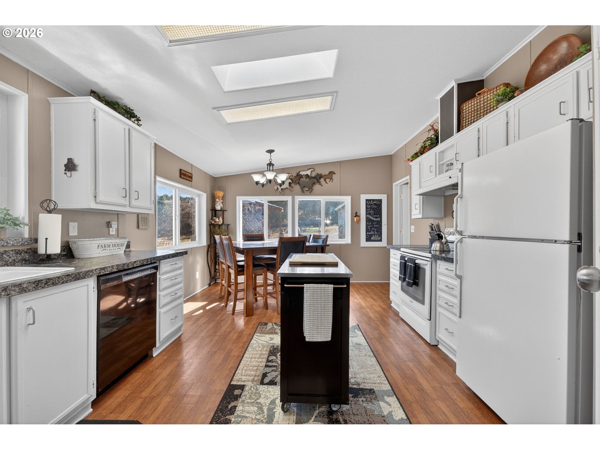 26548 County Road 74G John Day, OR 97845 - Photo 5 of 44 a kitchen with stainless steel appliances granite countertop a refrigerator a stove a sink dishwasher and white cabinets with wooden floor
