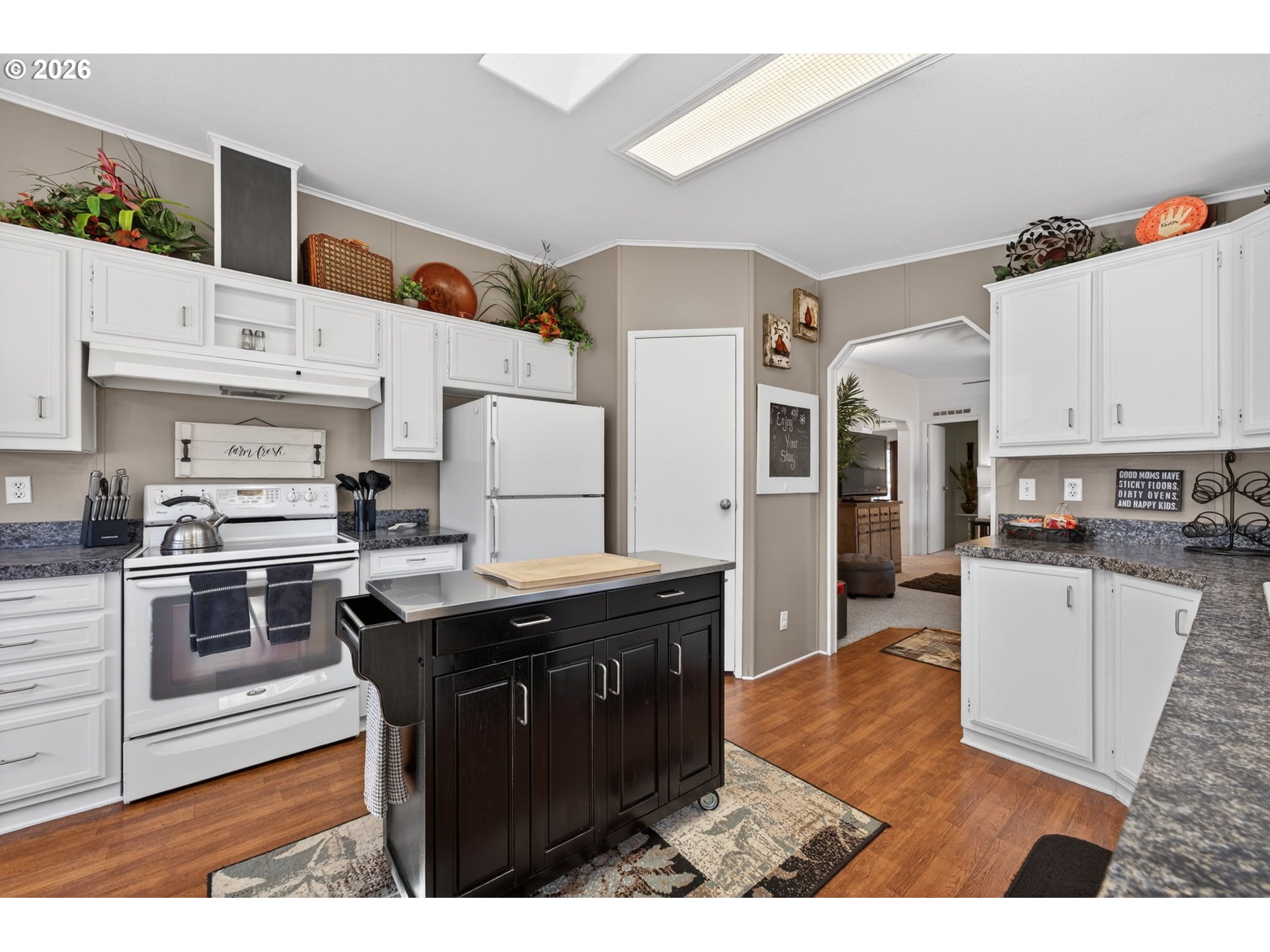 26548 County Road 74G John Day, OR 97845 - Photo 7 of 44 a kitchen with stainless steel appliances granite countertop a stove top oven a sink a refrigerator and white cabinets with wooden floor