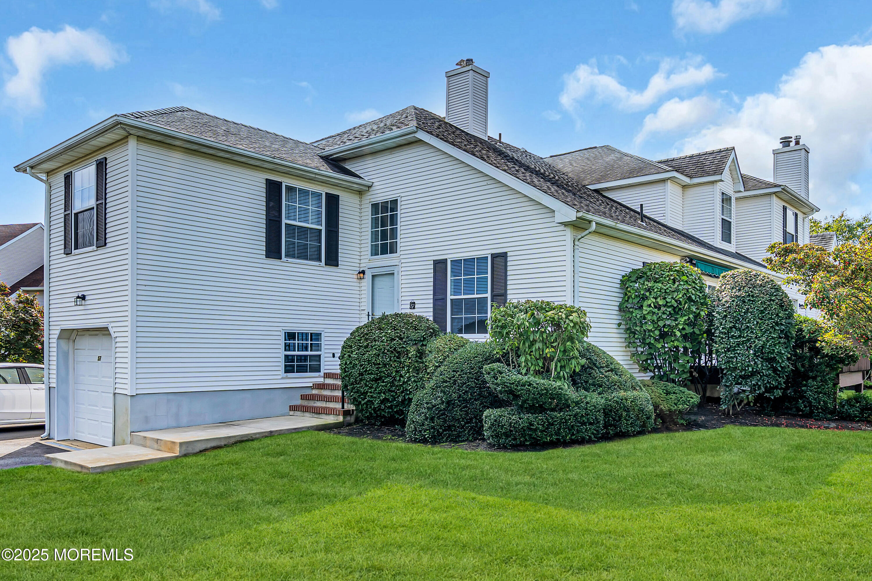 57 Racquet Road Wall, NJ 07719 - Photo 1 of 33 a view of a house with a yard and plants