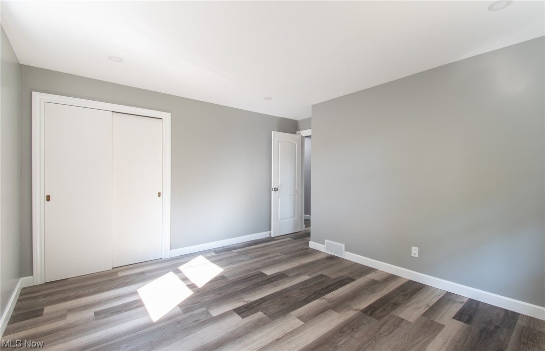1097 South Meridian Road Youngstown, OH 44511 - Photo 19 of 29 Unfurnished bedroom featuring dark hardwood flooring and a closet
