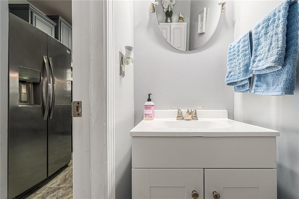1111 Watercourse Way Hampton, GA 30228 - Photo 14 of 30 a bathroom with a sink and a mirror