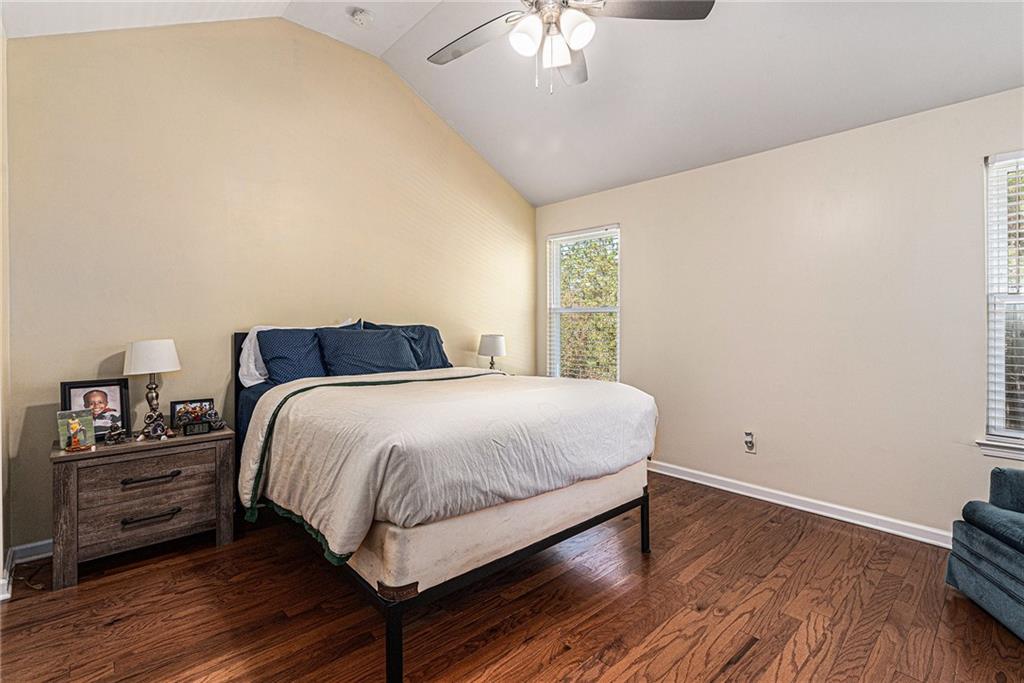1111 Watercourse Way Hampton, GA 30228 - Photo 15 of 30 a bedroom with a bed and wooden floor