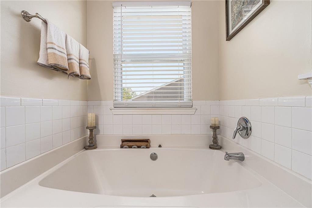 1111 Watercourse Way Hampton, GA 30228 - Photo 21 of 30 a white bath tub sitting in a bathroom