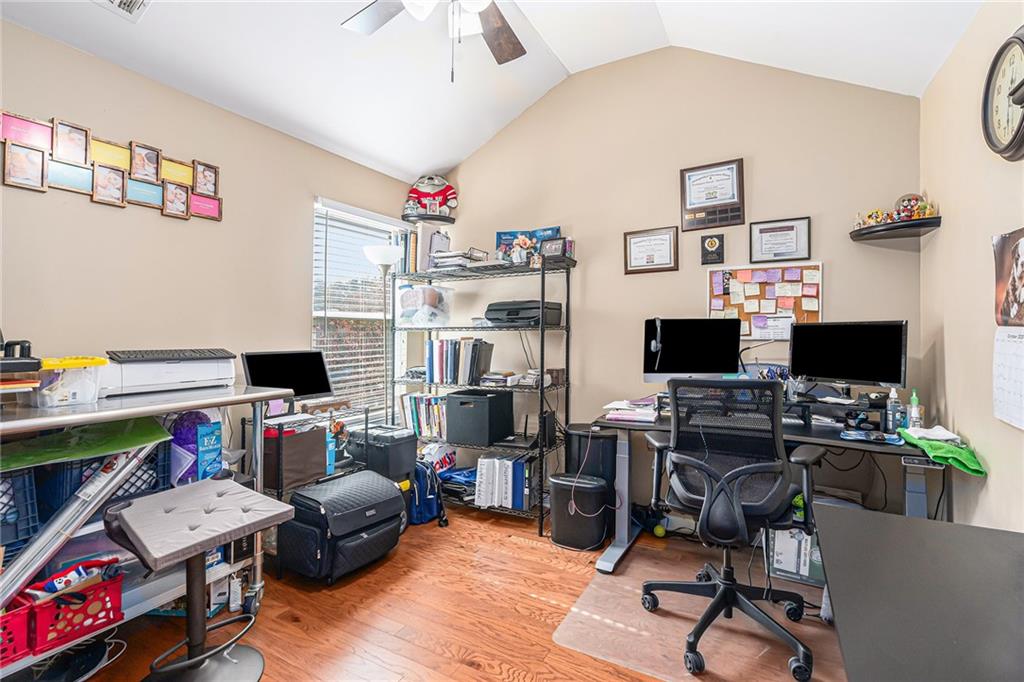 1111 Watercourse Way Hampton, GA 30228 - Photo 24 of 30 a view of a workspace with furniture and a window