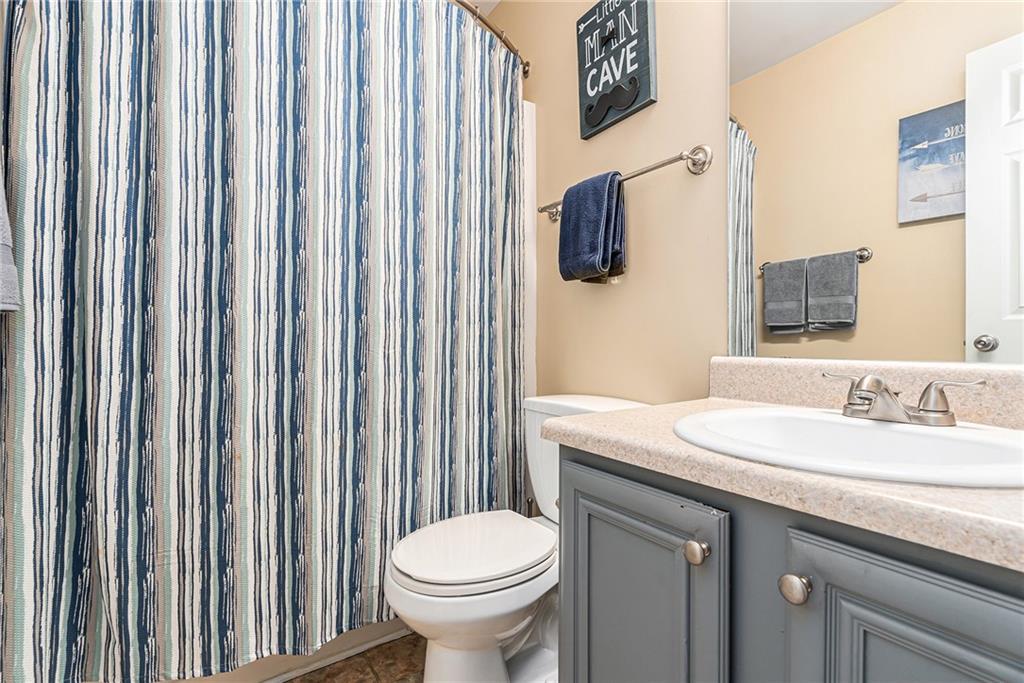 1111 Watercourse Way Hampton, GA 30228 - Photo 28 of 30 a bathroom with a sink toilet and shower