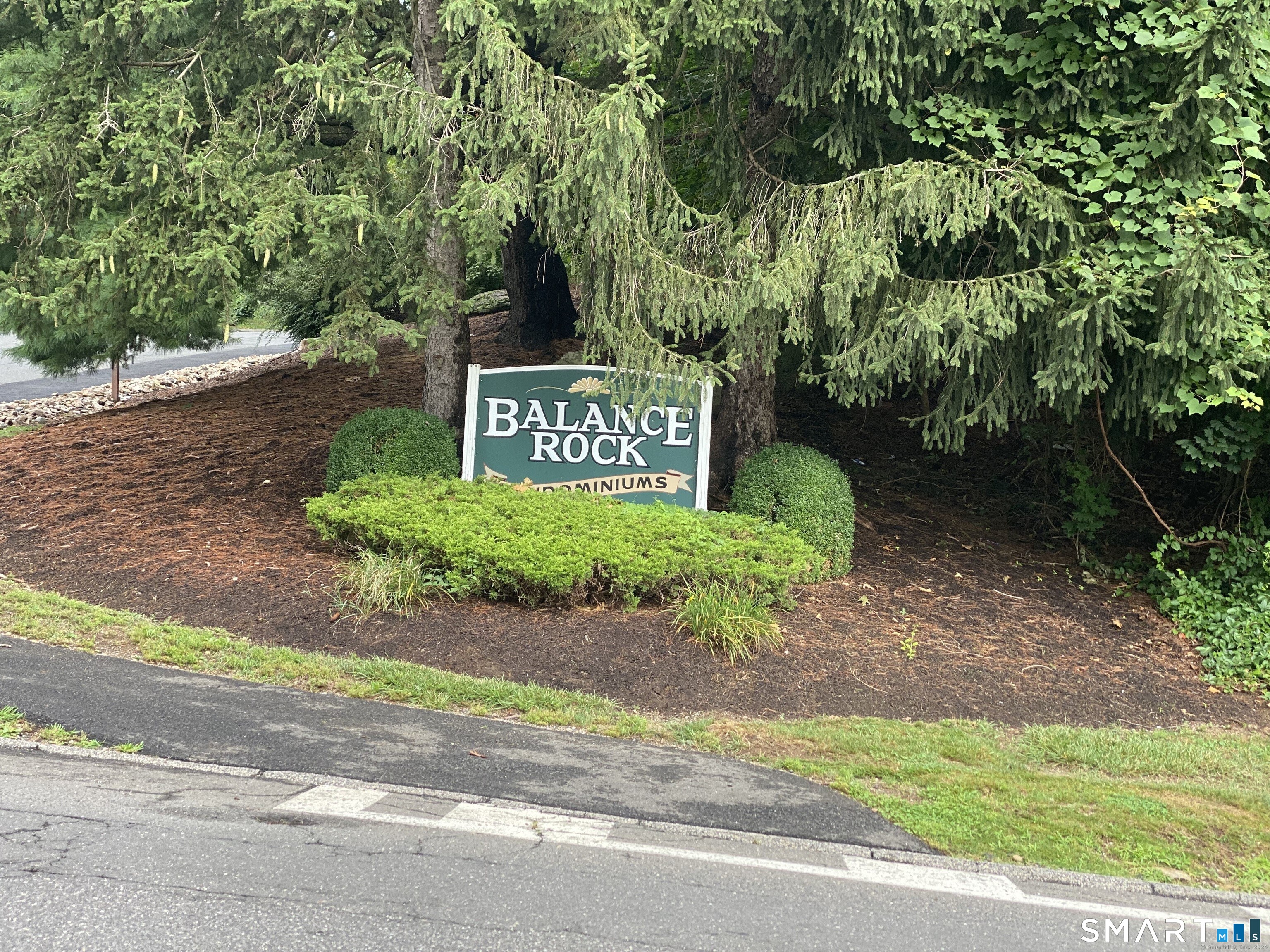 67 Balance Rock Road, Unit 7 Seymour, CT 06483 - Photo 2 of 12 a sign that is sitting on a side of a road