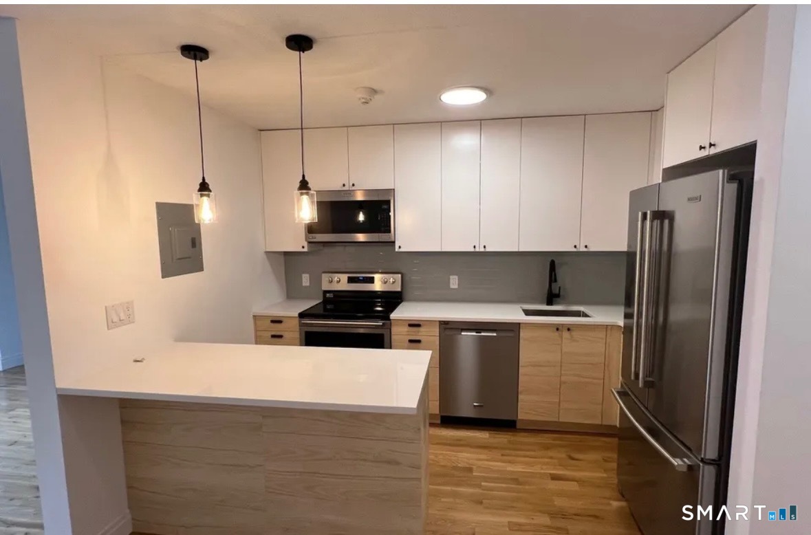 67 Balance Rock Road, Unit 7 Seymour, CT 06483 - Photo 3 of 12 a kitchen with stainless steel appliances a refrigerator sink and microwave