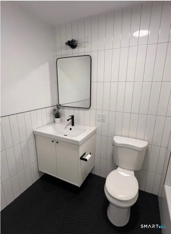 67 Balance Rock Road, Unit 7 Seymour, CT 06483 - Photo 8 of 12 a bathroom with a toilet sink and mirror