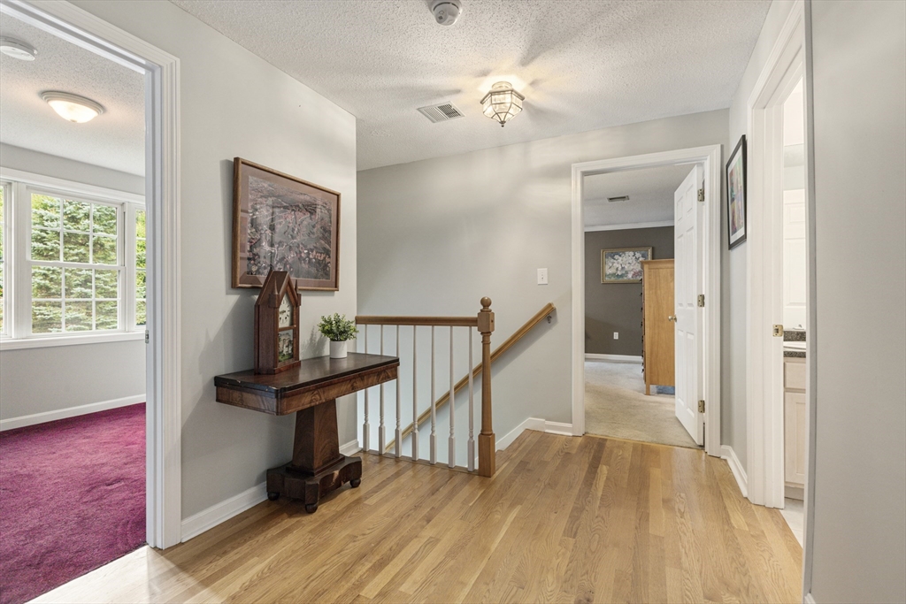 2 Gerald Avenue Millis, MA 02054 - Photo 21 of 38 a view of a hallway with wooden floor and staircase