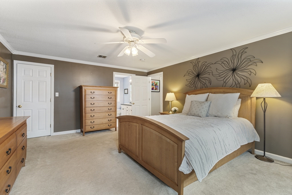 2 Gerald Avenue Millis, MA 02054 - Photo 22 of 38 a spacious bedroom with a bed and a chandelier