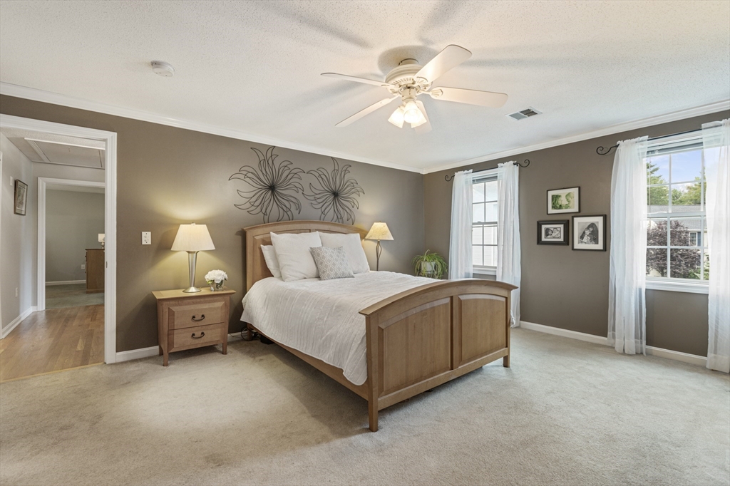 2 Gerald Avenue Millis, MA 02054 - Photo 23 of 38 a bedroom with a large bed chandelier and a window