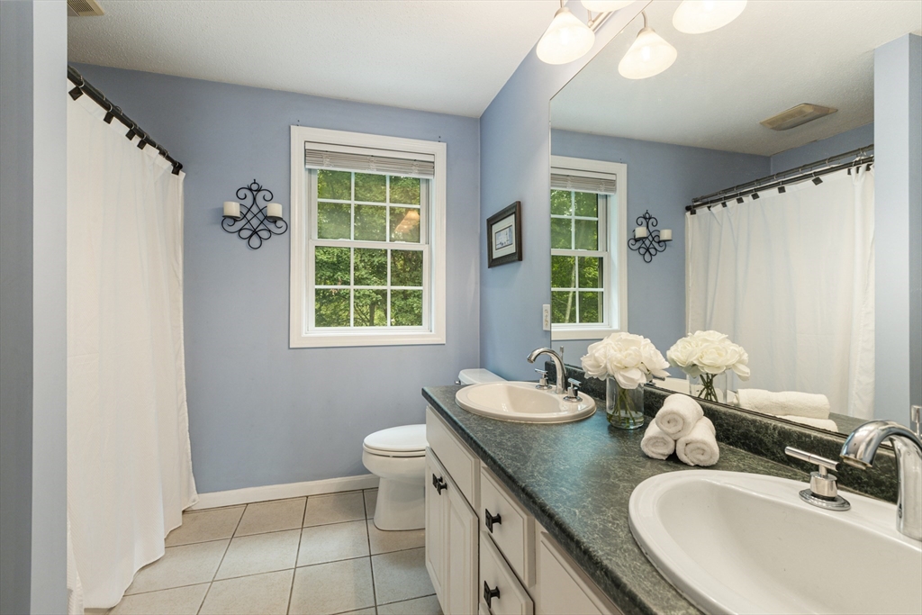 2 Gerald Avenue Millis, MA 02054 - Photo 25 of 38 a bathroom with a granite countertop sink mirror and a window