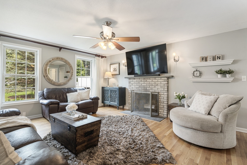 2 Gerald Avenue Millis, MA 02054 - Photo 4 of 38 a living room with furniture a fireplace and a large window