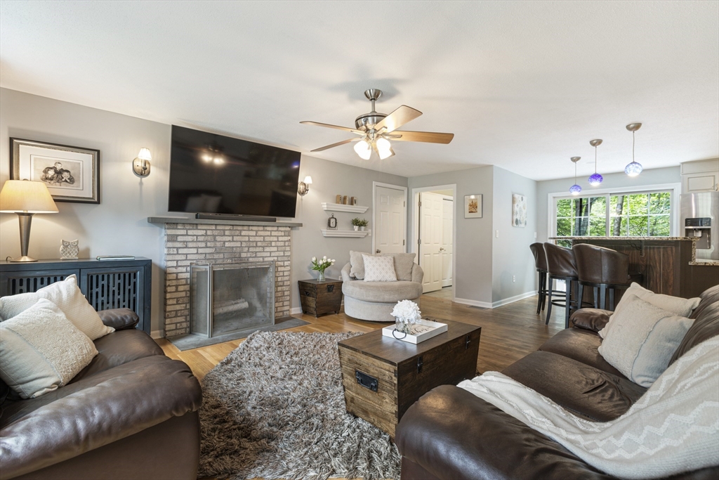 2 Gerald Avenue Millis, MA 02054 - Photo 5 of 38 a living room with furniture a fireplace and a flat screen tv