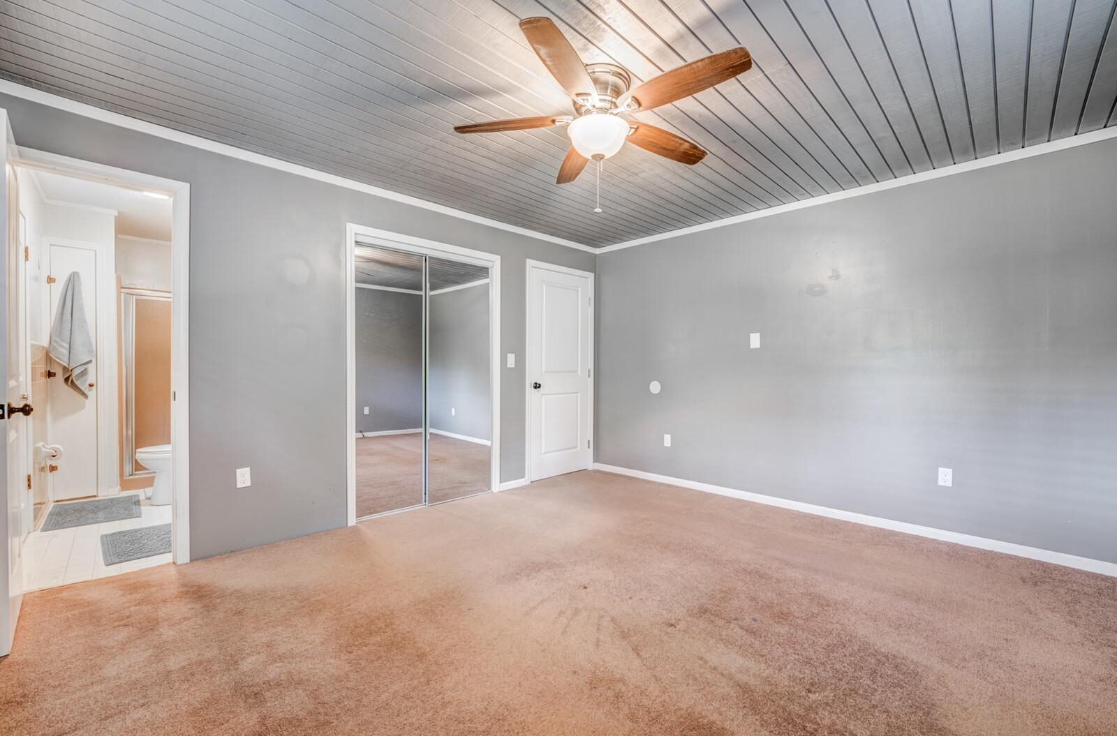 6125 Warren Road Oakland, TN 38060 - Photo 23 of 40 Spacious bedroom featuring neutral wall tones, textured ceiling, brown carpet flooring, and a ceiling fan with light fixture