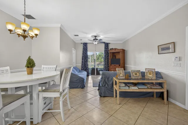 a view of a dining room with furniture and chandelier