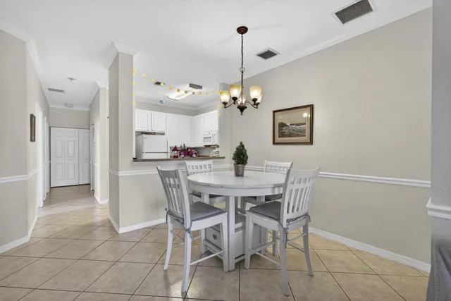 a kitchen with cabinets and chairs