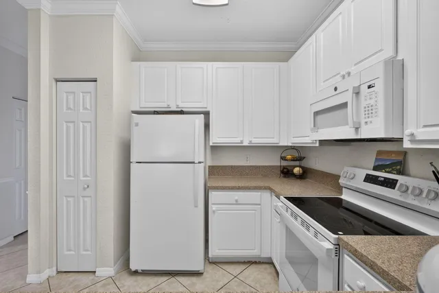 a kitchen with cabinets stainless steel appliances and a sink
