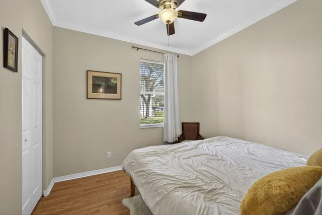 a bedroom with a bed and wooden floor