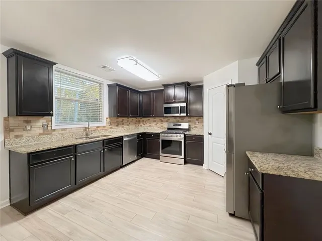 a view of an empty room with a chandelier fan