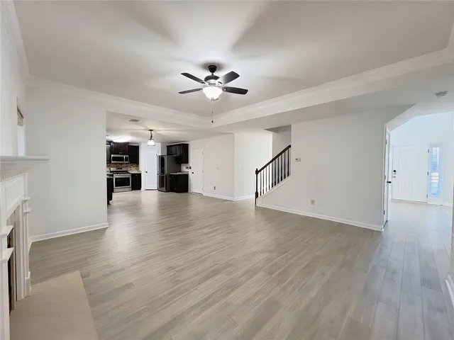 a view of a livingroom with wooden floor and fireplace