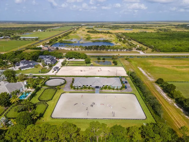 an aerial view of a house with a swimming pool and outdoor space