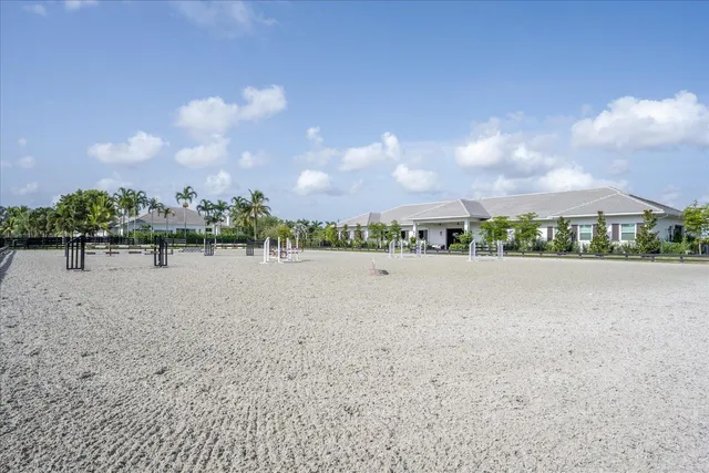 a view of a swimming pool with a table and chairs in patio