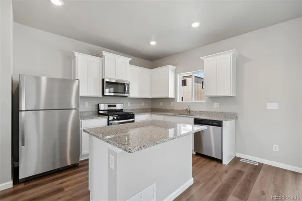 a kitchen with a refrigerator sink and microwave