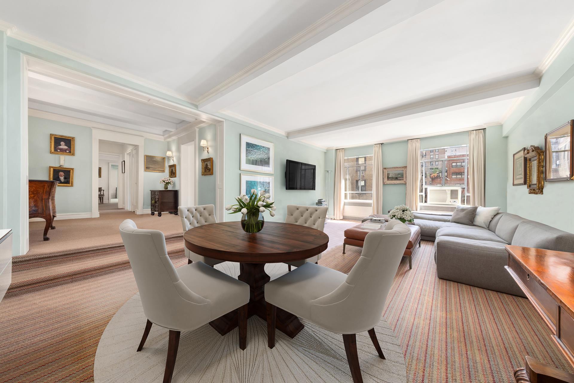 a view of a dining room with furniture and wooden floor
