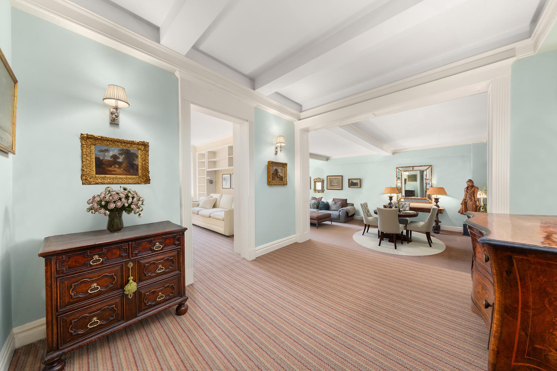 19 East 88th Street, Unit 9C Manhattan, NY 10128 - Photo 2 of 9 a living room with furniture and a wooden floor