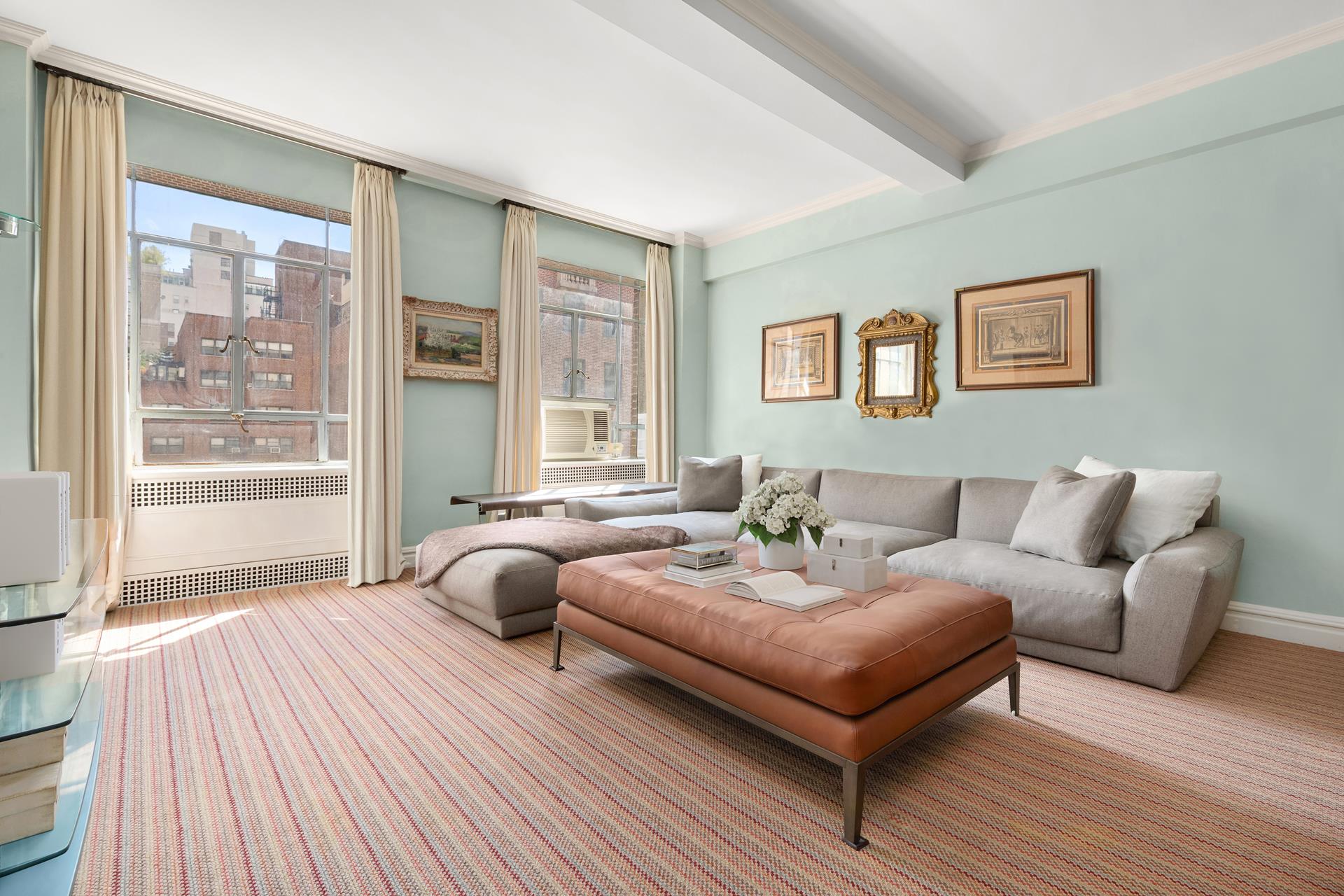 19 East 88th Street, Unit 9C Manhattan, NY 10128 - Photo 3 of 9 a bedroom with a bed and wooden floor