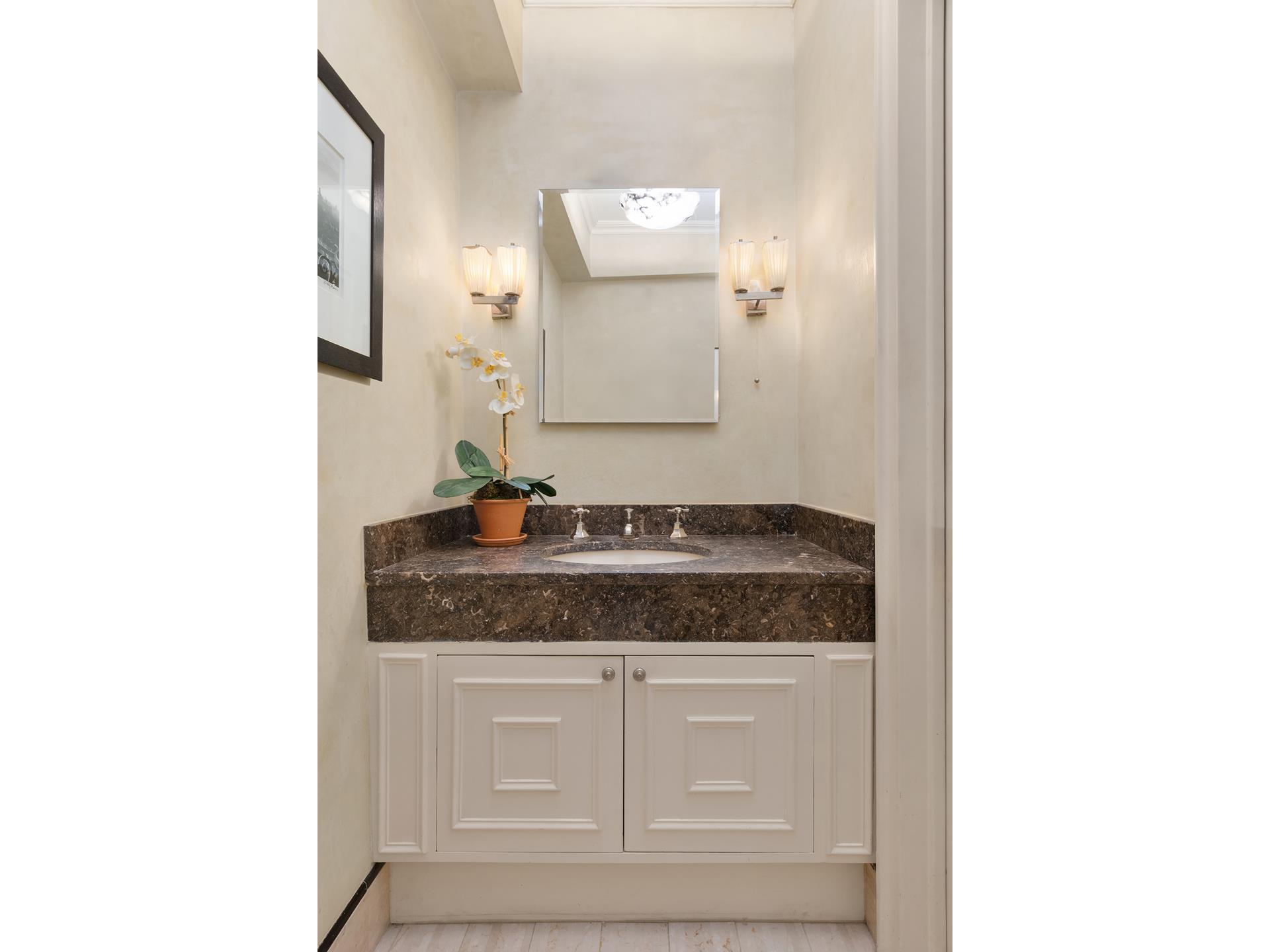 19 East 88th Street, Unit 9C Manhattan, NY 10128 - Photo 8 of 9 a bathroom with a granite countertop sink and a mirror