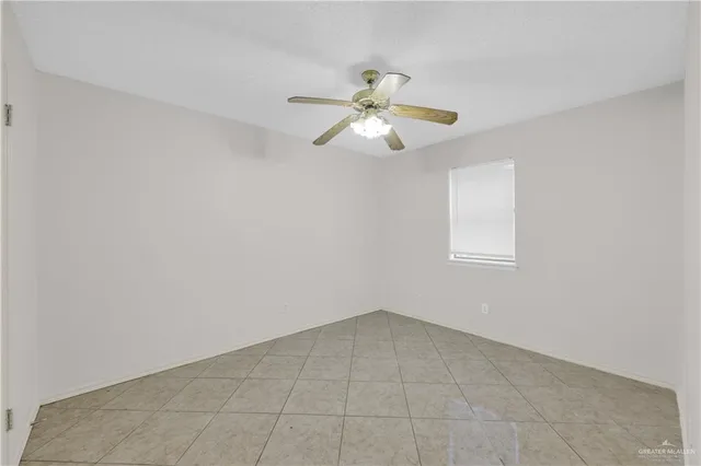 a view of a room with a ceiling fan and a chandelier fan