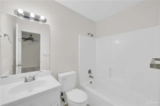 a bathroom with a sink toilet vanity and shower