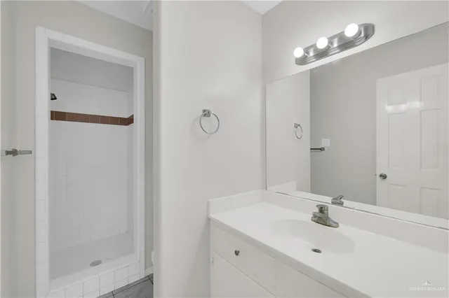 a bathroom with a sink a shower and a mirror