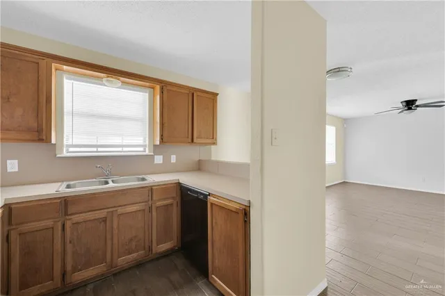 a kitchen with a sink cabinets and window