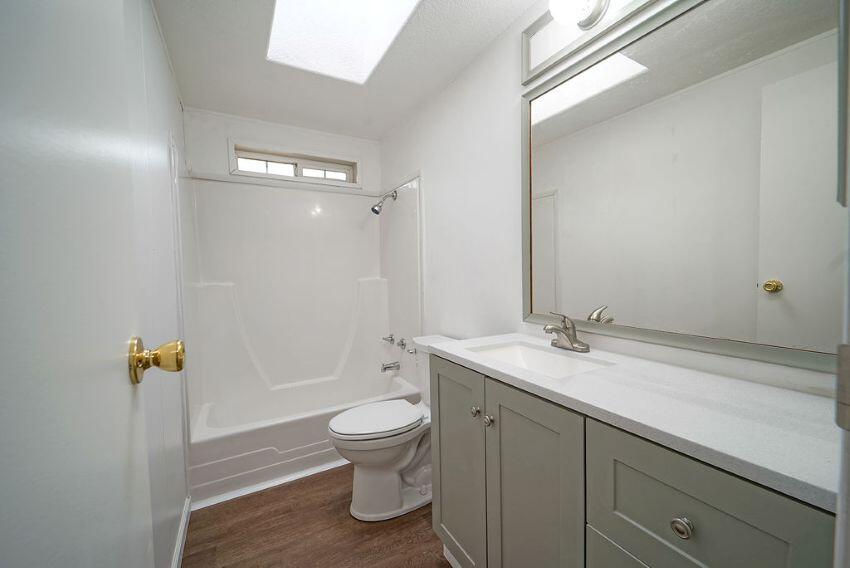 1291 Red Hill Road Junction City, CA 96048 - Photo 18 of 24 a bathroom with a granite countertop sink a toilet and a mirror