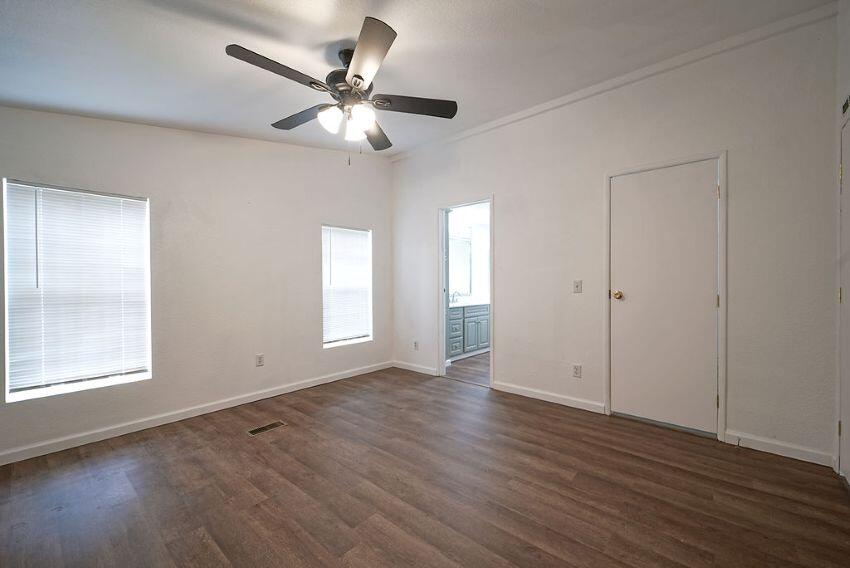 1291 Red Hill Road Junction City, CA 96048 - Photo 20 of 24 an empty room with wooden floor chandelier fan and windows