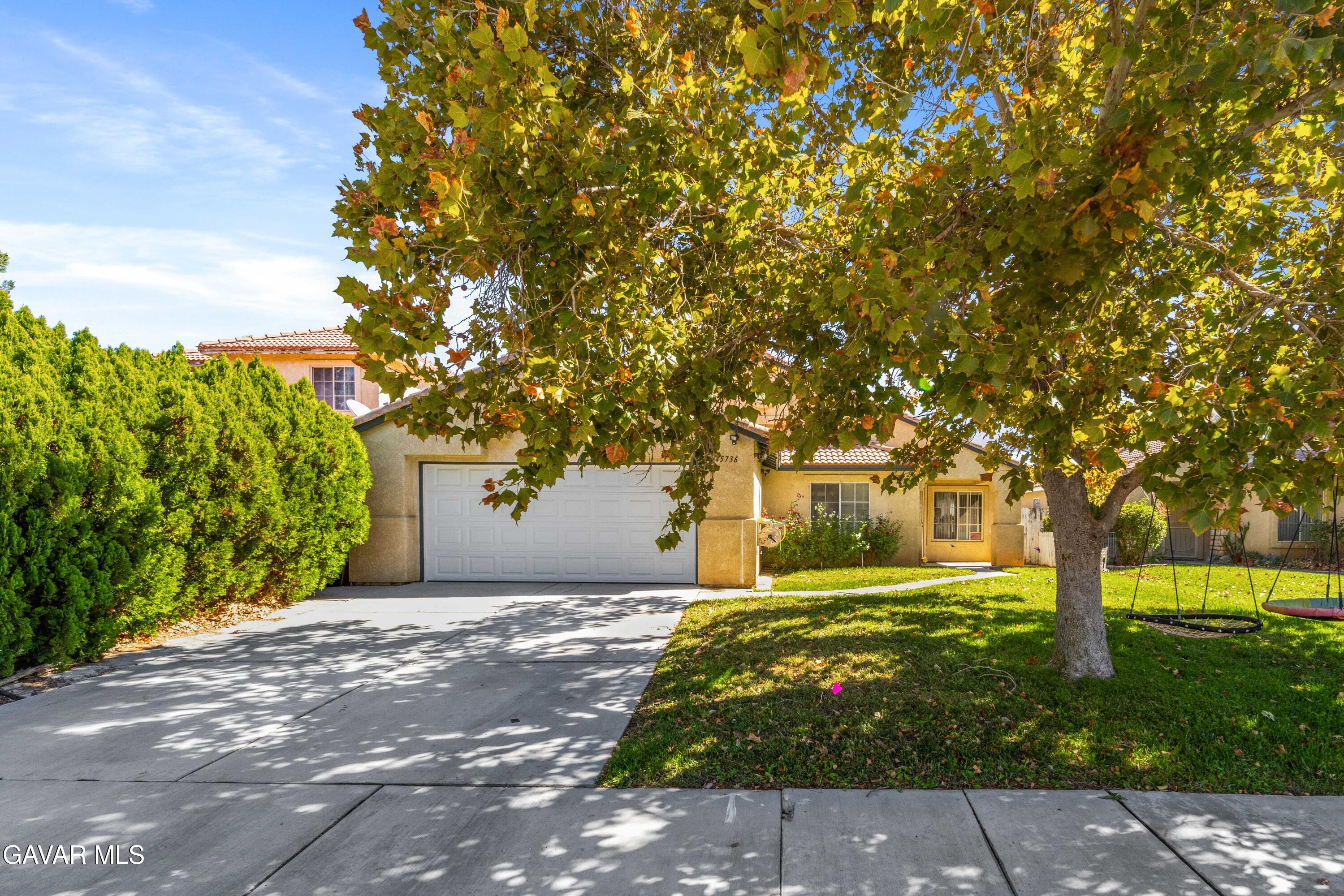 45736 Victoria Avenue Lancaster, CA 93534 - Photo 1 of 30 a front view of a house with a yard and tree