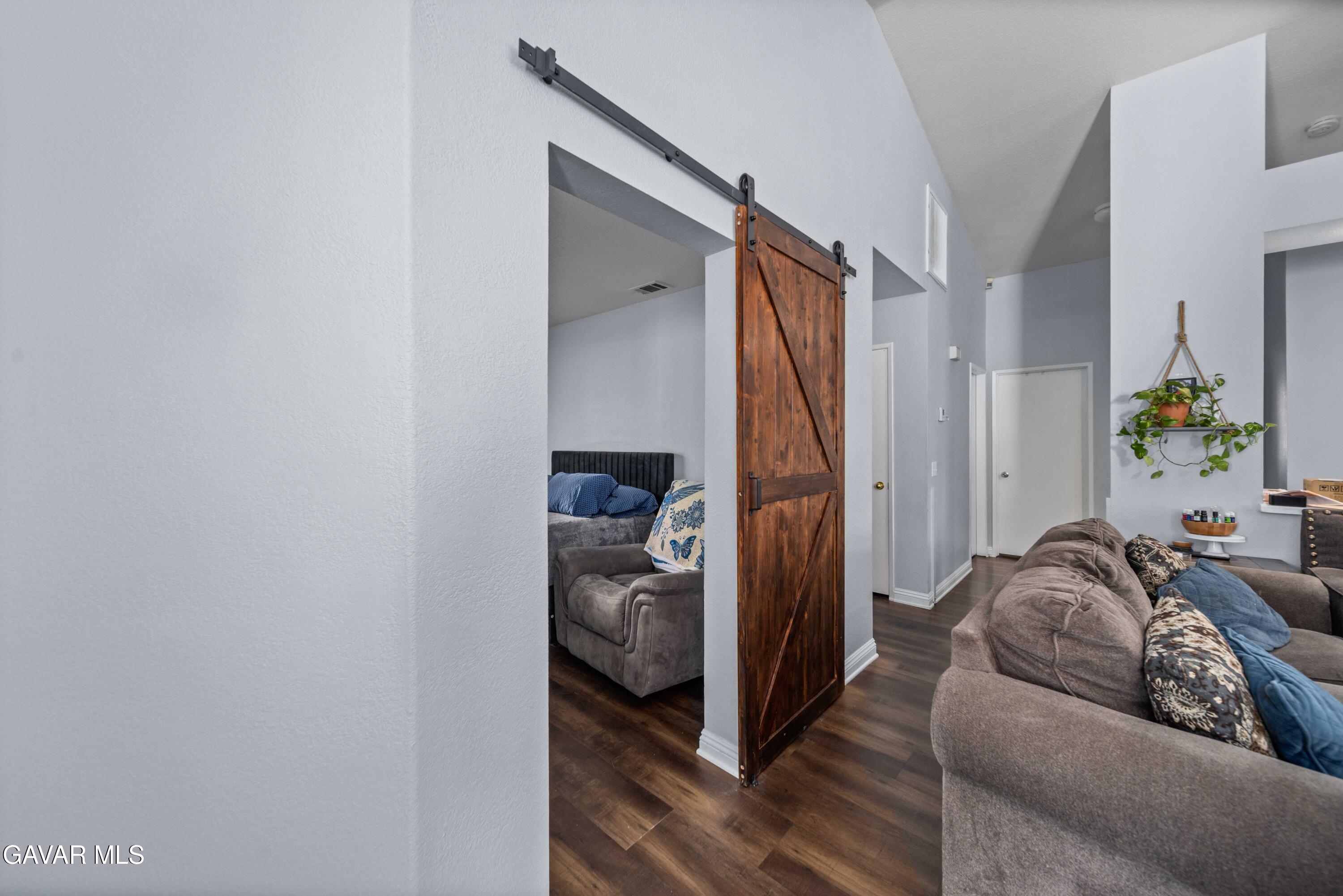 45736 Victoria Avenue Lancaster, CA 93534 - Photo 11 of 30 a living room with furniture and a walk in closet