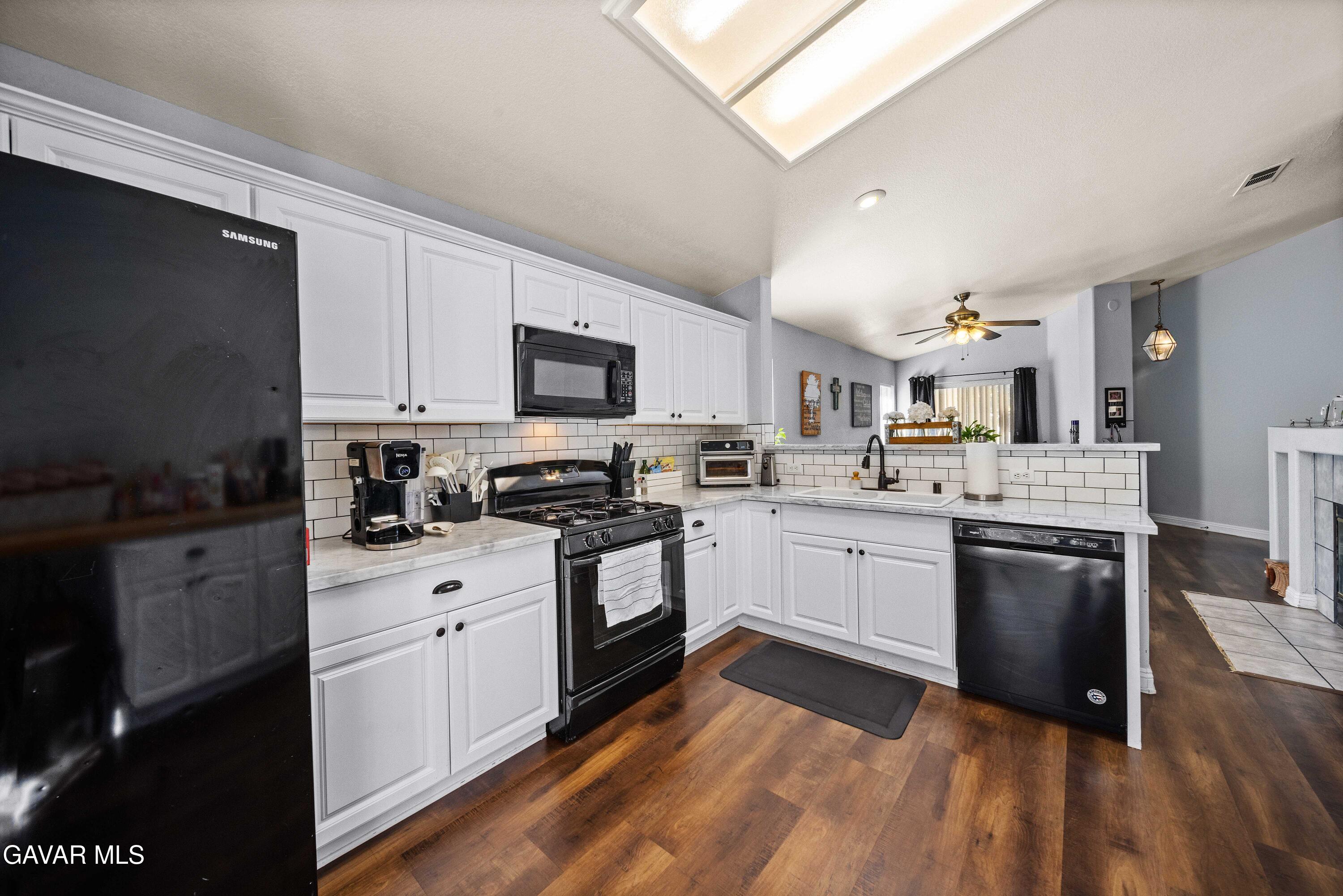 45736 Victoria Avenue Lancaster, CA 93534 - Photo 12 of 30 a kitchen with granite countertop appliances cabinets and a sink
