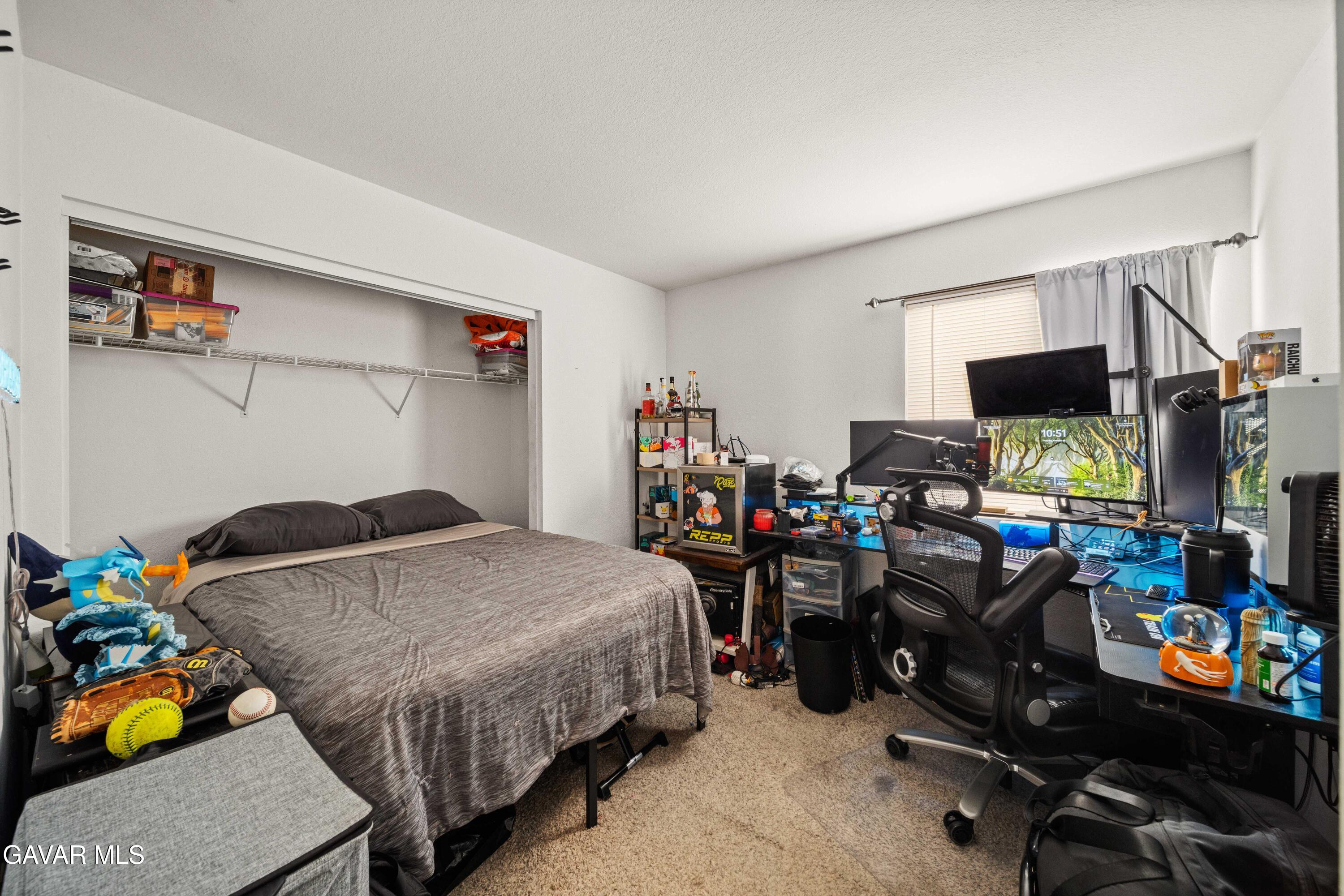 45736 Victoria Avenue Lancaster, CA 93534 - Photo 20 of 30 a bedroom with bed a computer on a desk and chair