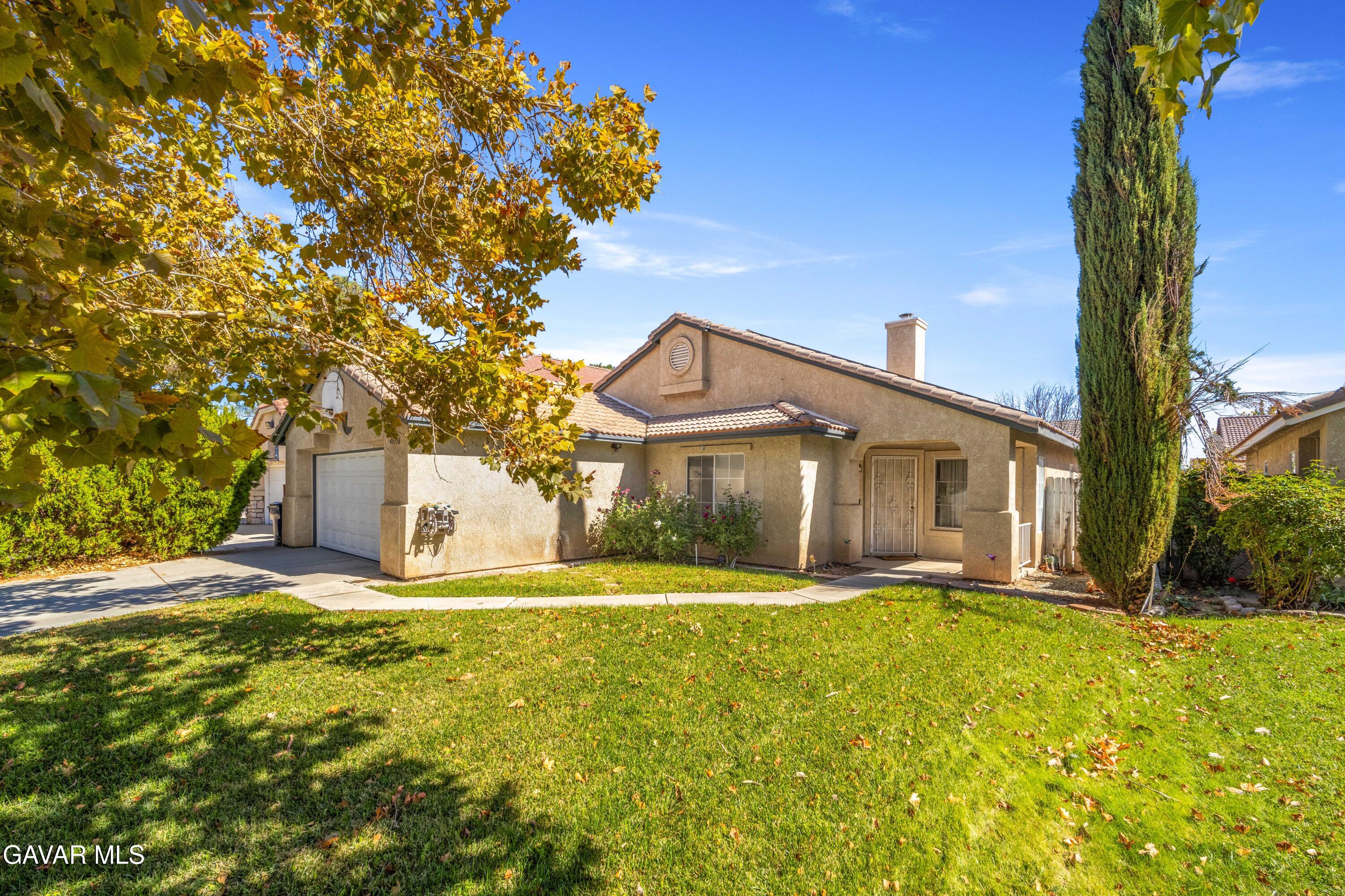 45736 Victoria Avenue Lancaster, CA 93534 - Photo 2 of 30 a big house with large trees in front of it
