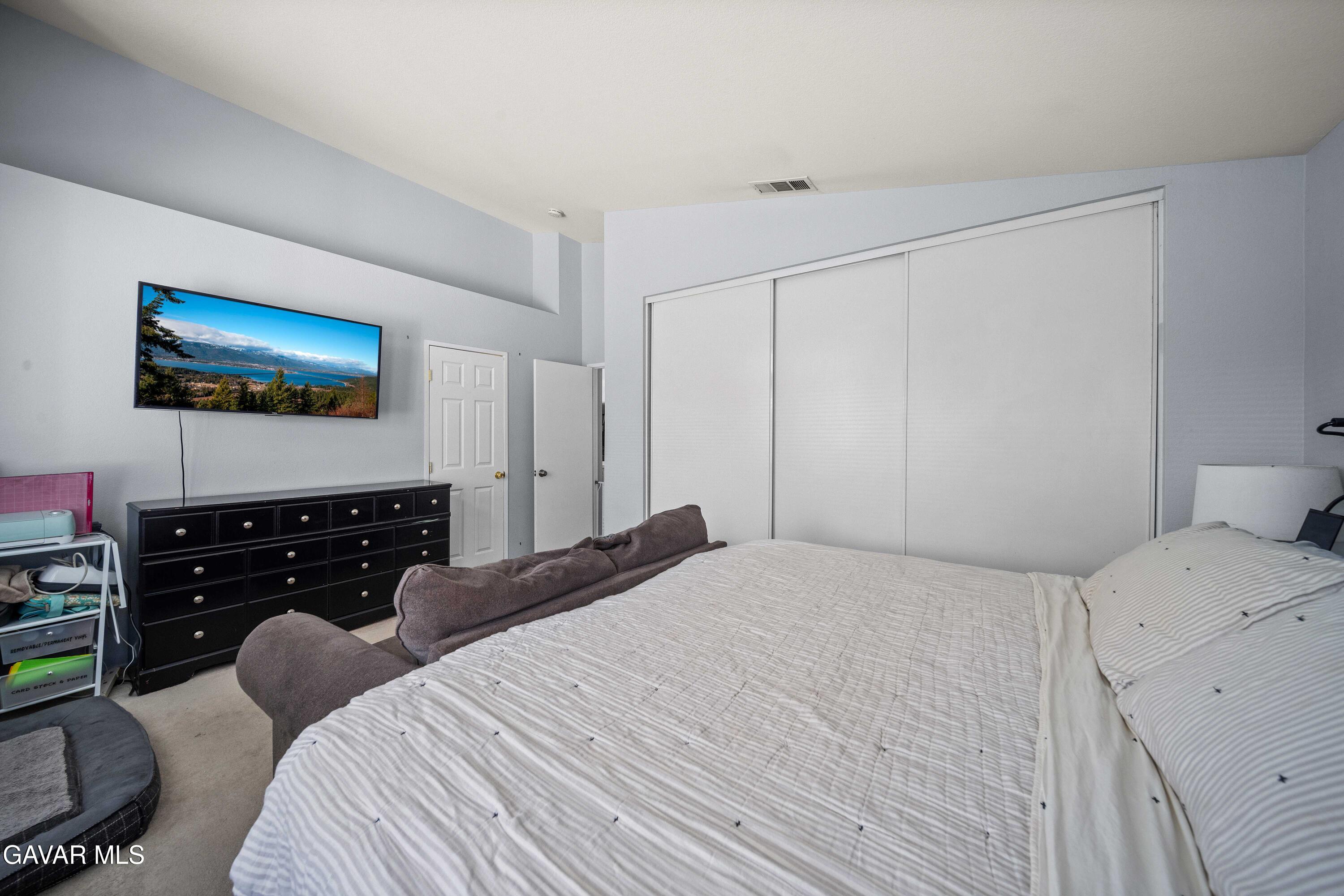 45736 Victoria Avenue Lancaster, CA 93534 - Photo 24 of 30 a bedroom with a bed and a flat screen tv