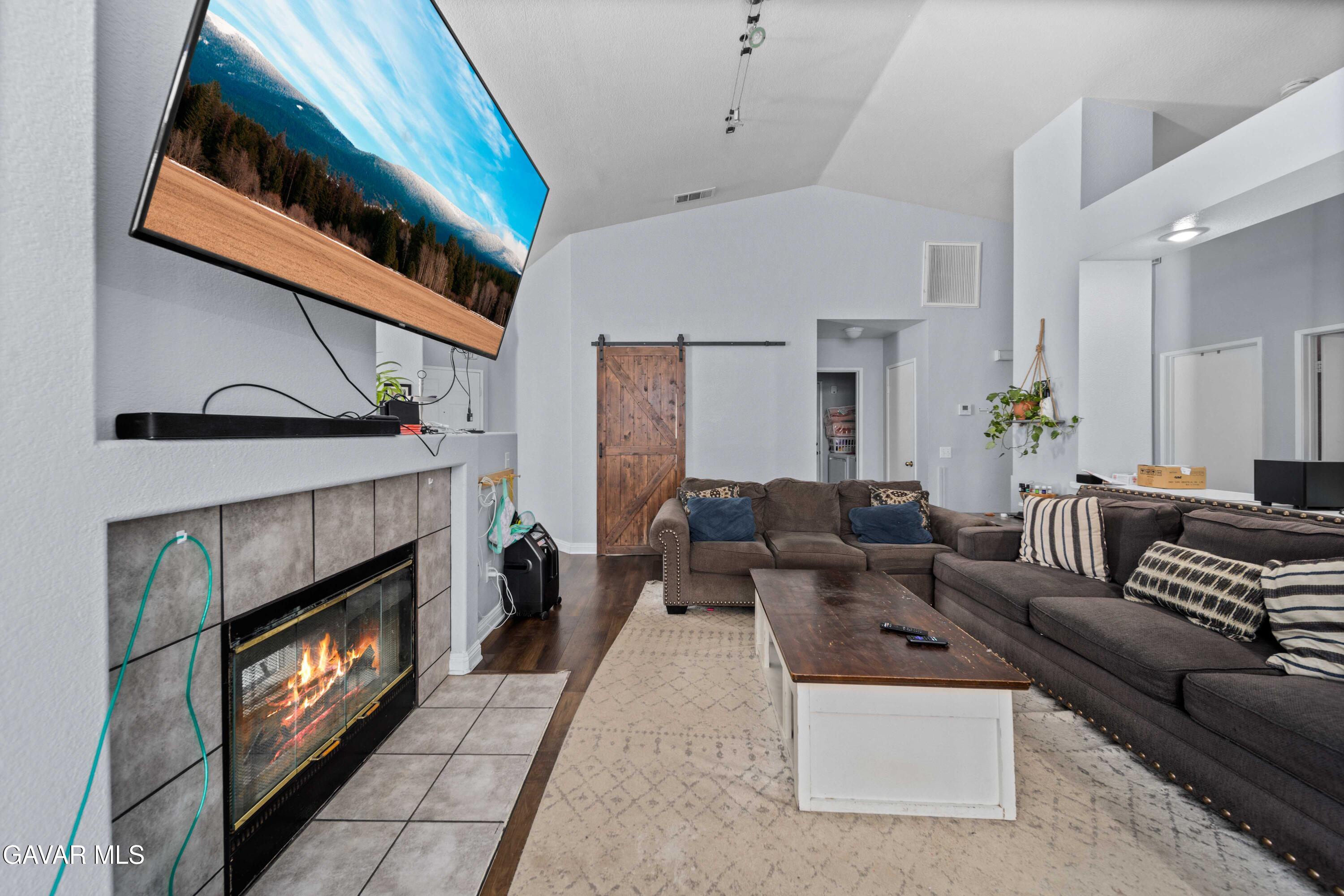 45736 Victoria Avenue Lancaster, CA 93534 - Photo 4 of 30 a living room with furniture a fireplace and a window