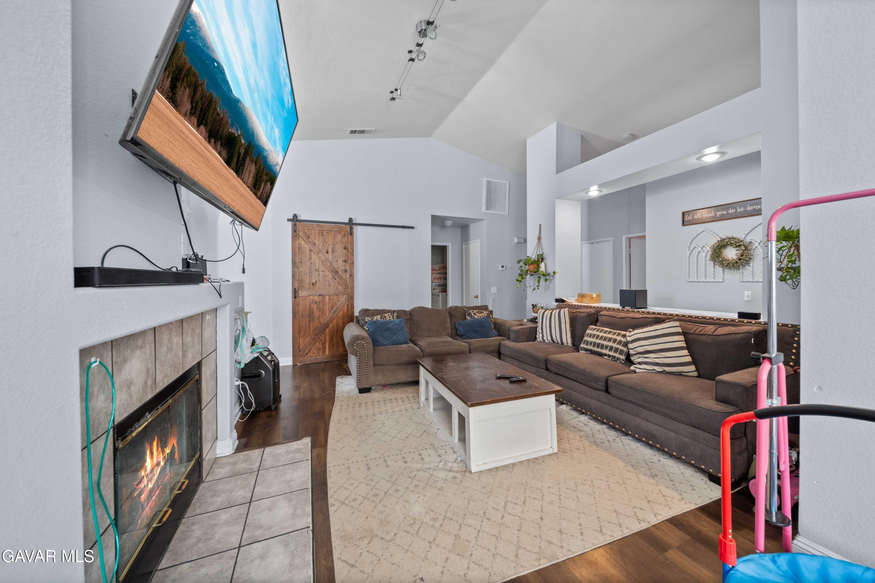 45736 Victoria Avenue Lancaster, CA 93534 - Photo 6 of 30 a living room with furniture and a fireplace