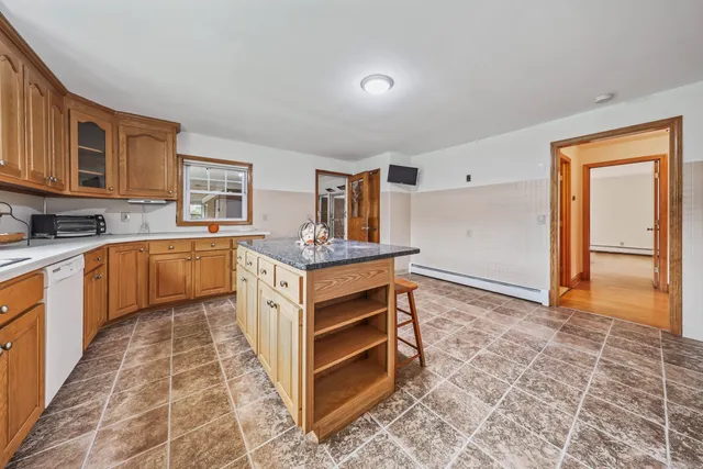 a kitchen with a stove sink and cabinets