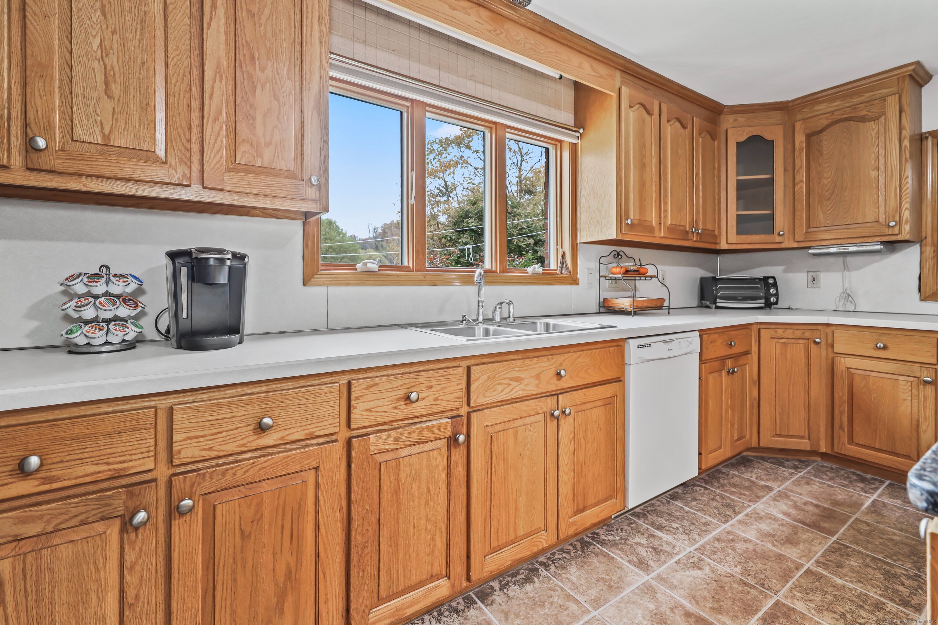 9 Sunset Drive Middlefield, CT 06481 - Photo 12 of 40 a kitchen with sink cabinets and window