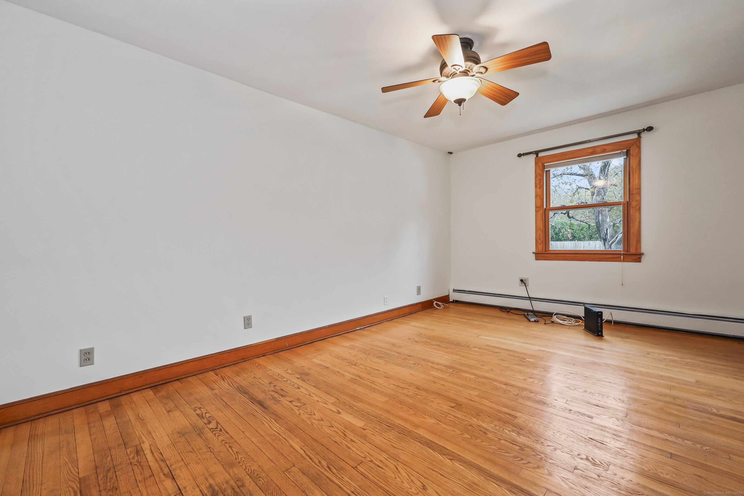 9 Sunset Drive Middlefield, CT 06481 - Photo 15 of 40 an empty room with wooden floor and windows